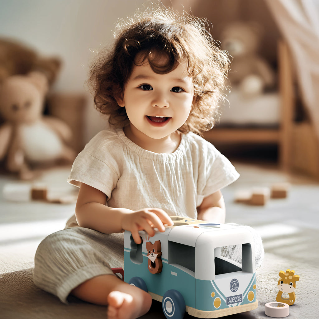 Child playing with a toy camper in a room with toys and furniture.